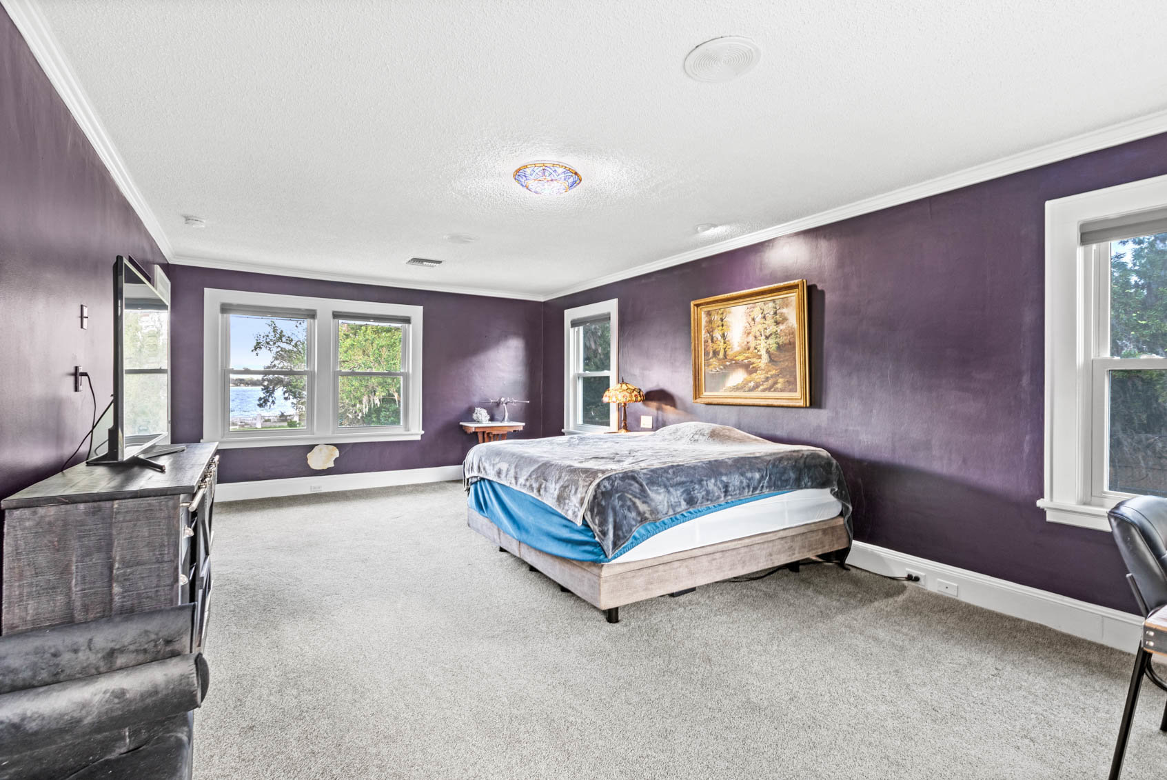 large bedroom with purple walls